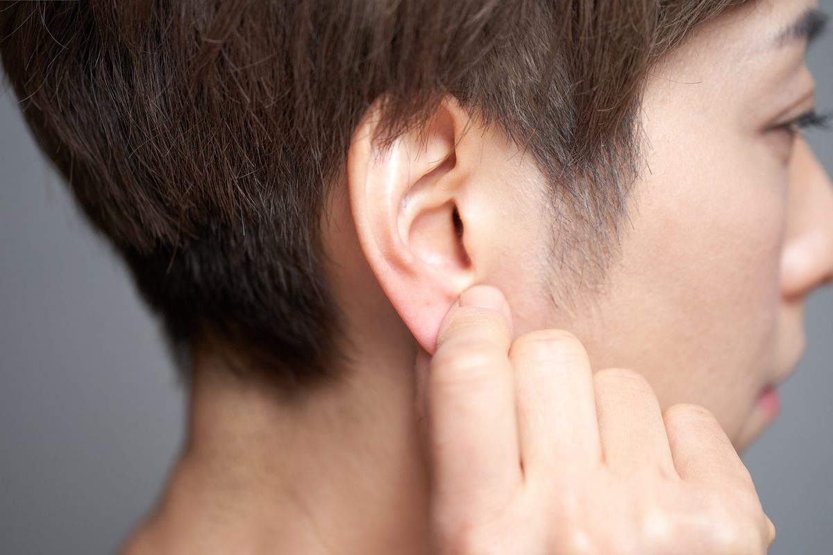 Earlobe repair patient holding earlobe